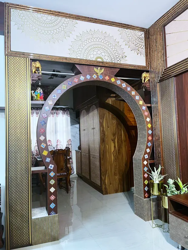 Wood-panelled wall with jaali screens beside the living area