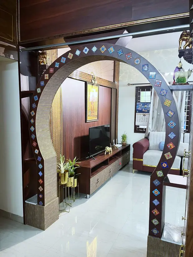 Wall-mounted TV console framed by an arched partition